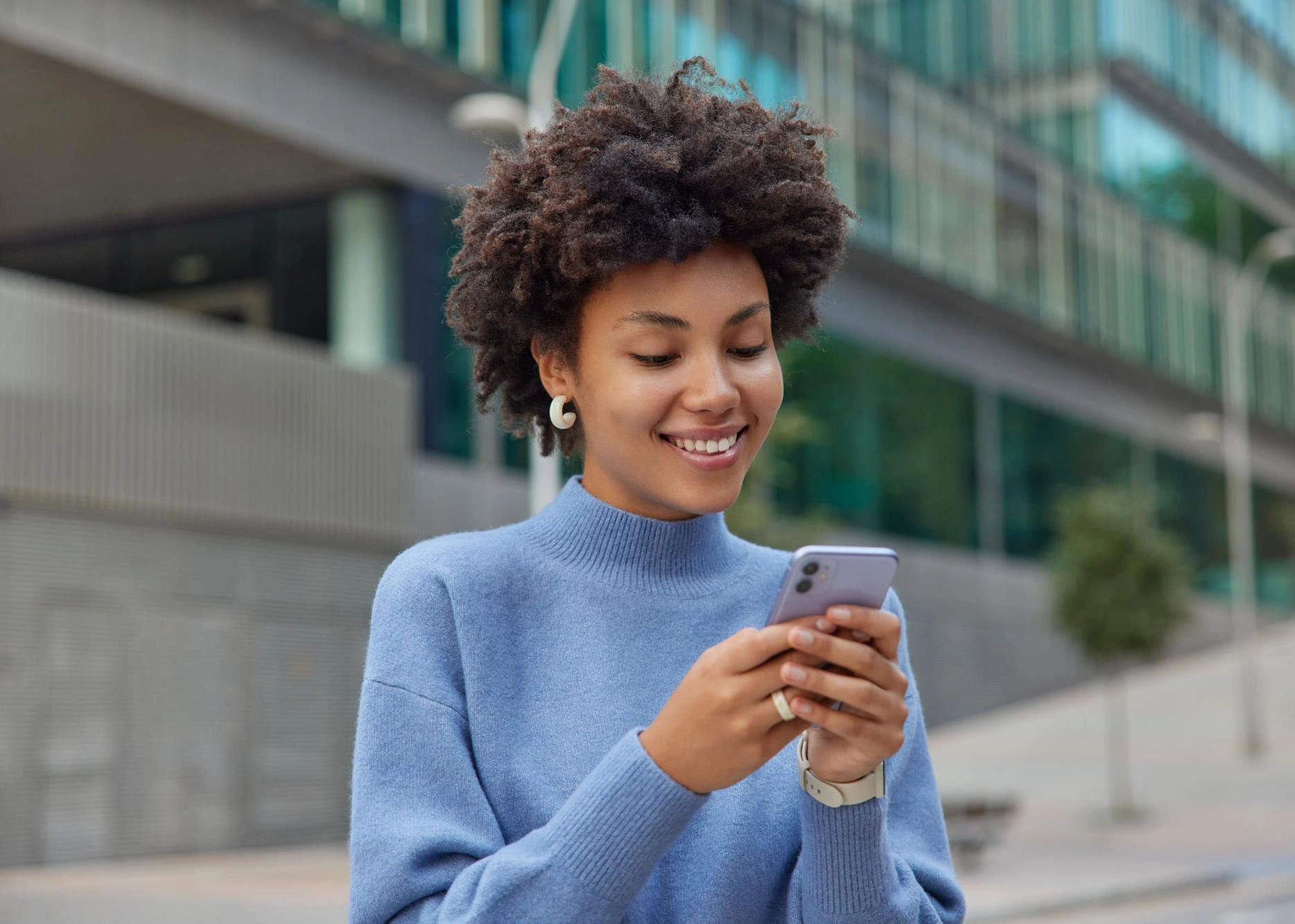 Woman checking her Lifeline wireless eligibility and available iPhone offers on her smartphone